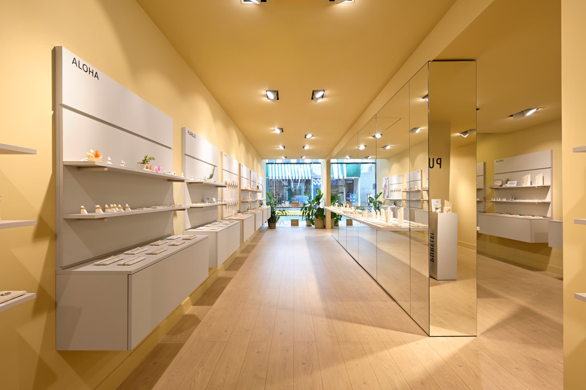 PURELEI refined retail interior with mirrored surfaces and integrated display systems