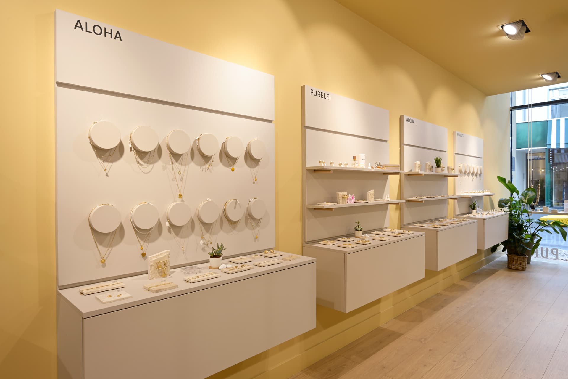 PURELEI custom furniture and product presentation integrated into the final store architecture