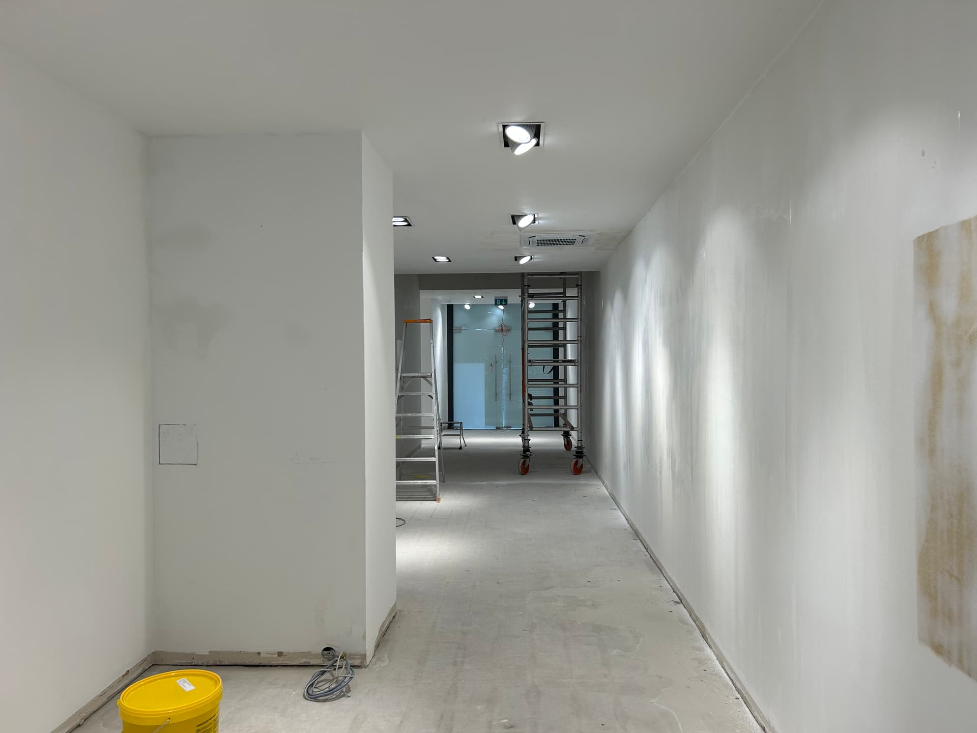 Before - PURELEI main retail axis transformed from fit-out shell to finished store interior