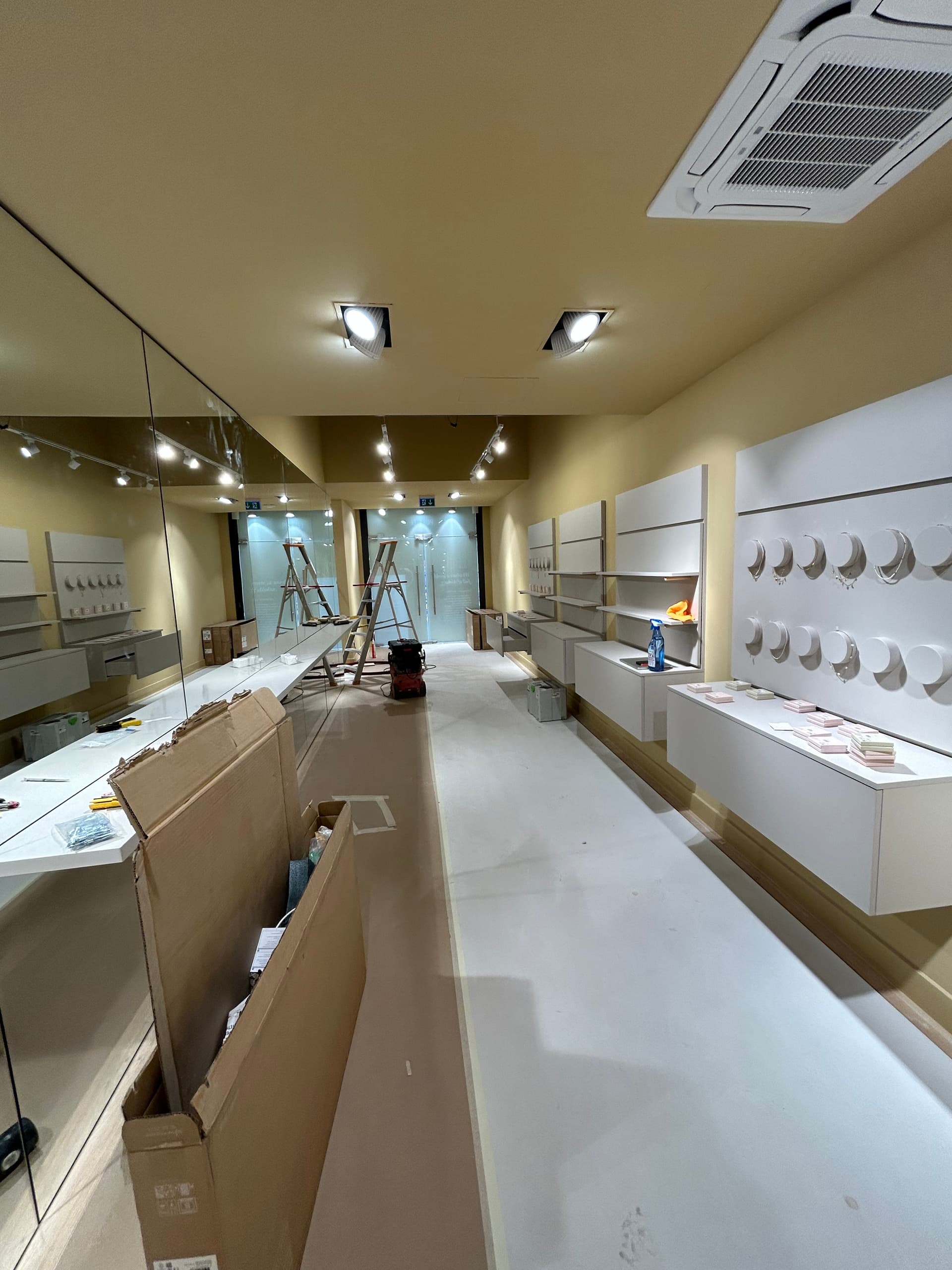 PURELEI interior fit-out showing fixtures and shelves being installed