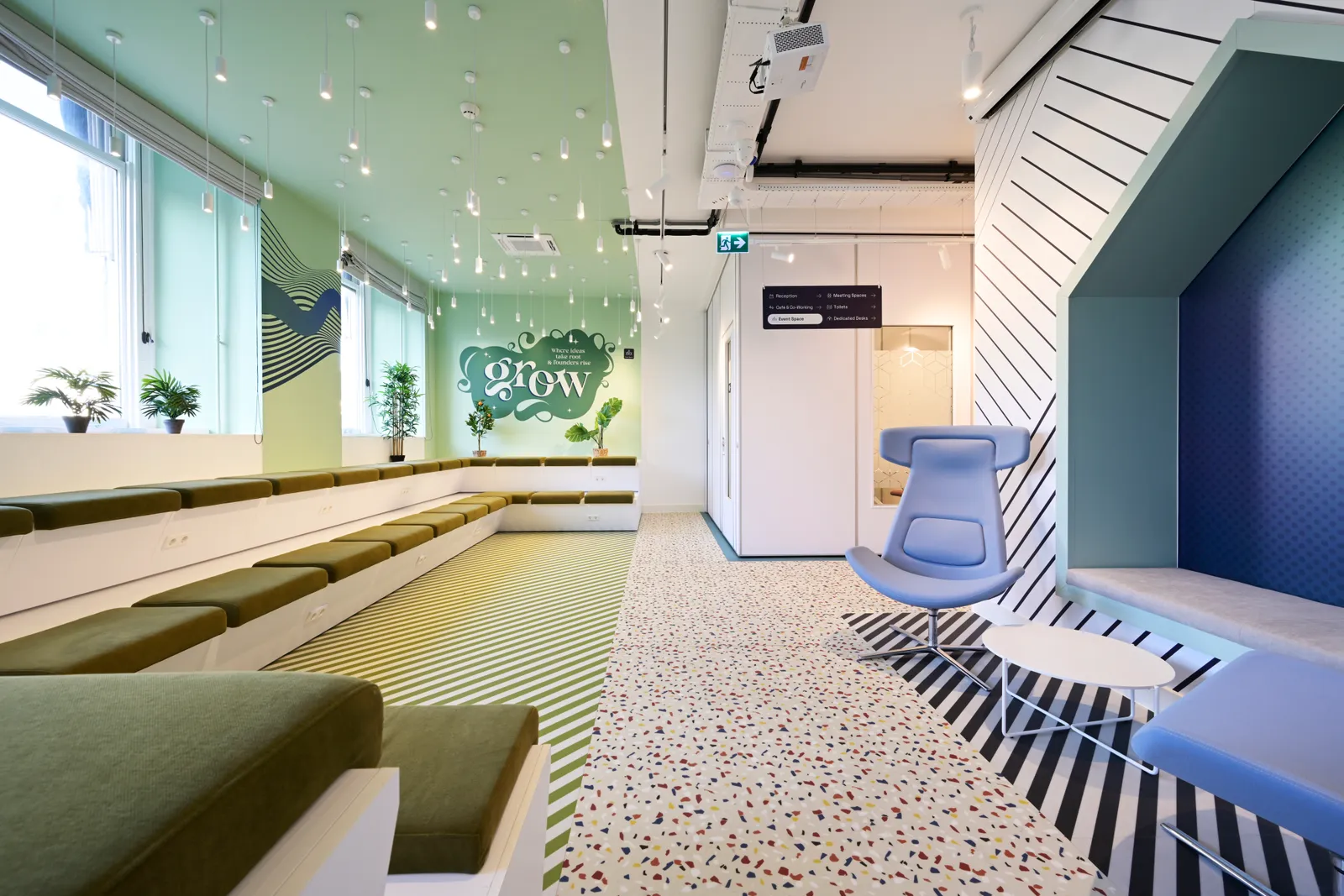 Unusual Spaces finished collaborative lounge with graphic flooring, integrated seating, and meeting pod in Utrecht