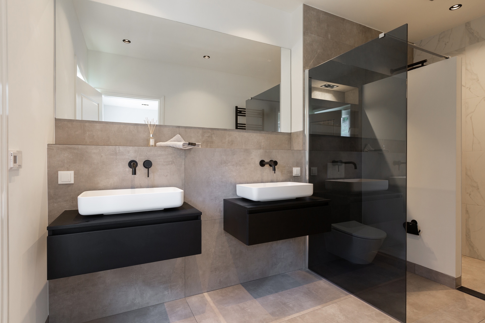 Completed Wassenaar bathroom with twin basins and bespoke floating cabinets